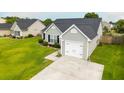 Aerial view of the home's light-gray siding, black roof, attached one car garage, and lush green yard at 137 Salem Creek Dr, Goose Creek, SC 29445