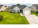 Well-maintained single-story home with an attached one car garage, dark roof, and beautiful landscaping at 137 Salem Creek Dr, Goose Creek, SC 29445