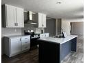 Bright kitchen featuring white cabinets, stainless steel appliances, and a stylish kitchen island, blending functionality with modern design at 1420 Rehoboth Rd, Cottageville, SC 29435
