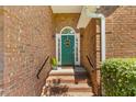 Welcoming front door with brick steps, decorative wreath, sidelights and black railings at 1441 Waterside Ct, Mount Pleasant, SC 29464