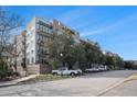 Brick apartment building featuring balconies and lush landscaping at 145 Pier View St # 111, Charleston, SC 29492
