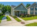 Charming home with a well-manicured lawn, colorful flowerbeds, and a convenient detached garage at 1607 Roustabout Way, Charleston, SC 29414