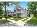 Charming two-story home with a welcoming porch and balcony surrounded by green landscaping and sidewalks at 1844 Hubbell Dr, Mount Pleasant, SC 29466