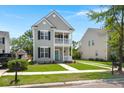Charming two-story home features a welcoming porch and balcony surrounded by green grass and a driveway at 1844 Hubbell Dr, Mount Pleasant, SC 29466
