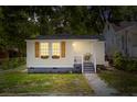 Charming home featuring fresh paint, inviting front porch, and meticulously manicured landscaping at 1915 Quitman St, North Charleston, SC 29405