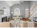 Cozy living room featuring a fireplace, vaulted ceilings, and an abundance of natural light at 2009 Arundel Pl, Mount Pleasant, SC 29464