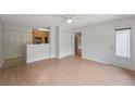 Bright living area with wood-look floors, white ceiling fan and access to the kitchen and balcony at 2011 N Highway 17 # 1400P, Mount Pleasant, SC 29466