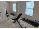 Neutral bedroom with built in mirrors and workout space bathed in natural light at 232 Moon Dance Ln, Summerville, SC 29483