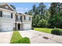 A welcoming townhome featuring a well-kept lawn and a convenient one-car garage at 234 S Lamplighter Ln, Summerville, SC 29486