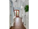 Grand entryway features a beautiful wood door, hardwood floors, and elegant trim details at 2668 Crooked Stick Ln, Mount Pleasant, SC 29466