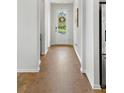 Bright entryway features light walls, wood floors, and a front door view of the outdoors at 2722 Sunrose Ln, Johns Island, SC 29455