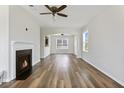 Bright living room features a decorative fireplace and hardwood floors, creating a warm and inviting space at 302 Mossy Wood Rd, Summerville, SC 29483