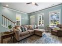 Bright living room featuring a plush sectional sofa, a patterned rug and light-colored walls with decorative trim at 312 Barberry St, Summerville, SC 29483