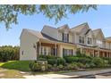 Well-maintained townhome with a landscaped front yard and charming facade at 312 Kelsey Blvd, Wando, SC 29492