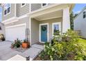 Inviting front porch with a teal door, white columns, landscaping, and a two-car garage at 331 Saddlewood Dr, Charleston, SC 29414