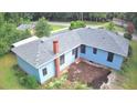 Aerial view of home highlighting a new gray roof, light blue siding, and space for landscaping in the backyard at 365 W Pine St, Varnville, SC 29944
