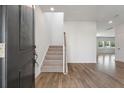 Bright entryway with hardwood floors and staircase with neutral carpeting at 425 W Respite Ln, Summerville, SC 29483