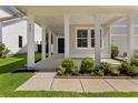 Inviting covered front porch with white columns, manicured bushes and well maintained walkway at 425 W Respite Ln, Summerville, SC 29483