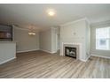 Bright, open living room with fireplace, light wood flooring, and neutral walls at 45 Scyamore Ave # 623, Charleston, SC 29407