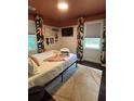 Cozy bedroom with natural light, dark wood floors, accent rug, and colorful patterned curtains at 5010 Converse St, North Charleston, SC 29405