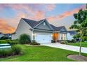 Single-Gathering home with tidy landscaping, attached garage, and a welcoming driveway offers a peaceful curb appeal at 554 Tidewater Chase Ln, Summerville, SC 29486