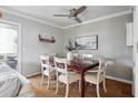 Cozy dining area with wood table and seating for six, adjacent to the living room and kitchen at 623 Bay Tree Ct, Mount Pleasant, SC 29464