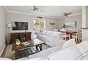 Comfortable living room featuring a white sofa, a large TV, and sliding door access to the porch at 623 Bay Tree Ct, Mount Pleasant, SC 29464