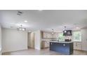 Open-concept kitchen with a central island and modern light fixtures at 670 Dupre Rd, McClellanville, SC 29458
