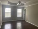 Bright bedroom with tray ceilings, wood floors, neutral walls and ample natural light from two windows at 687 Ponderosa Dr, Charleston, SC 29414