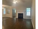 Spacious living room featuring gleaming dark wood floors, a fireplace, and an open layout at 687 Ponderosa Dr, Charleston, SC 29414