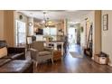 Open-concept living room with hardwood floors flowing into the dining area and kitchen at 7322 Stoney Moss Way, Hanahan, SC 29410