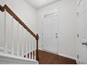 Bright entryway with hardwood floors and staircase leading to the upper level at 854 Bibury Ct, Charleston, SC 29414