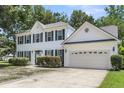 Beautiful two-story home with white siding, green shutters, and attached two-car garage at 9253 N Moreto Cir, Summerville, SC 29485