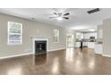 Spacious living room with fireplace, hardwood floors, and open layout to the kitchen and dining area at 9253 N Moreto Cir, Summerville, SC 29485