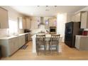 Well-equipped kitchen featuring modern appliances, gray cabinets, and an island with bar seating at 103 Granton Edge Ln, Summerville, SC 29486