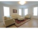 Bright living room featuring hardwood floors, neutral walls, a cream couch, and a large window at 103 Granton Edge Ln, Summerville, SC 29486