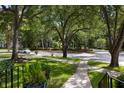 Scenic street view with mature trees and a well-maintained sidewalk at 1067 Loyalist Ln, Mount Pleasant, SC 29464