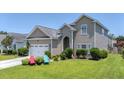 Charming two-story home features a well-maintained lawn, inviting entrance, and attached garage at 112 Worthington Dr, Moncks Corner, SC 29461