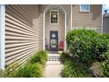 Inviting front entry features a charming porch, a welcoming door, and lush landscaping at 112 Worthington Dr, Moncks Corner, SC 29461