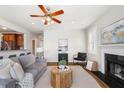 Comfortable living room featuring a fireplace, ceiling fan, and hardwood floors at 123 Gaslight Blvd, Summerville, SC 29483
