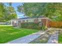 Brick home with a lush green lawn, an American flag on the porch, and a paved driveway at 131 Harvey Ave, Goose Creek, SC 29445