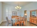 Bright dining room with chandelier, wooden furniture, and decor for a cozy ambiance at 139 Back Tee Cir, Summerville, SC 29485