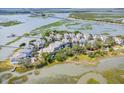 Drone shot capturing a beautiful coastal community with marsh views and elevated homes and bridge at 1621 Folly Creek Way # D-8, Charleston, SC 29412