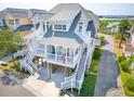 Lovely coastal home on stilts with dual balconies, showcasing classic design and serene neighborhood setting at 1621 Folly Creek Way # D-8, Charleston, SC 29412