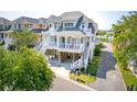 Charming coastal home with elevated structure, white railings, and multiple covered porches, perfect for waterfront living at 1621 Folly Creek Way # D-8, Charleston, SC 29412