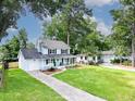 Inviting two-story home with a well-manicured lawn, long driveway, and classic architectural details at 2020 Piper Dr, Charleston, SC 29407