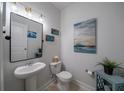 Stylish half bath with a pedestal sink and modern decor at 2024 Lanneau Ln, Johns Island, SC 29455