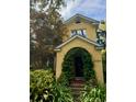 Exterior shot of home featuring a charming arched entryway and lush landscaping at 2066 Wappoo Dr, Charleston, SC 29412