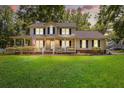 Charming two-story home featuring a spacious porch, manicured lawn, and inviting curb appeal at 207 Littlejohn St, Summerville, SC 29483