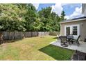 View of a spacious backyard with a table and chairs on a patio at 2106 Clipstone Dr, Ladson, SC 29456